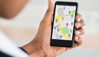 Close up of a woman holding her phone and checking maps